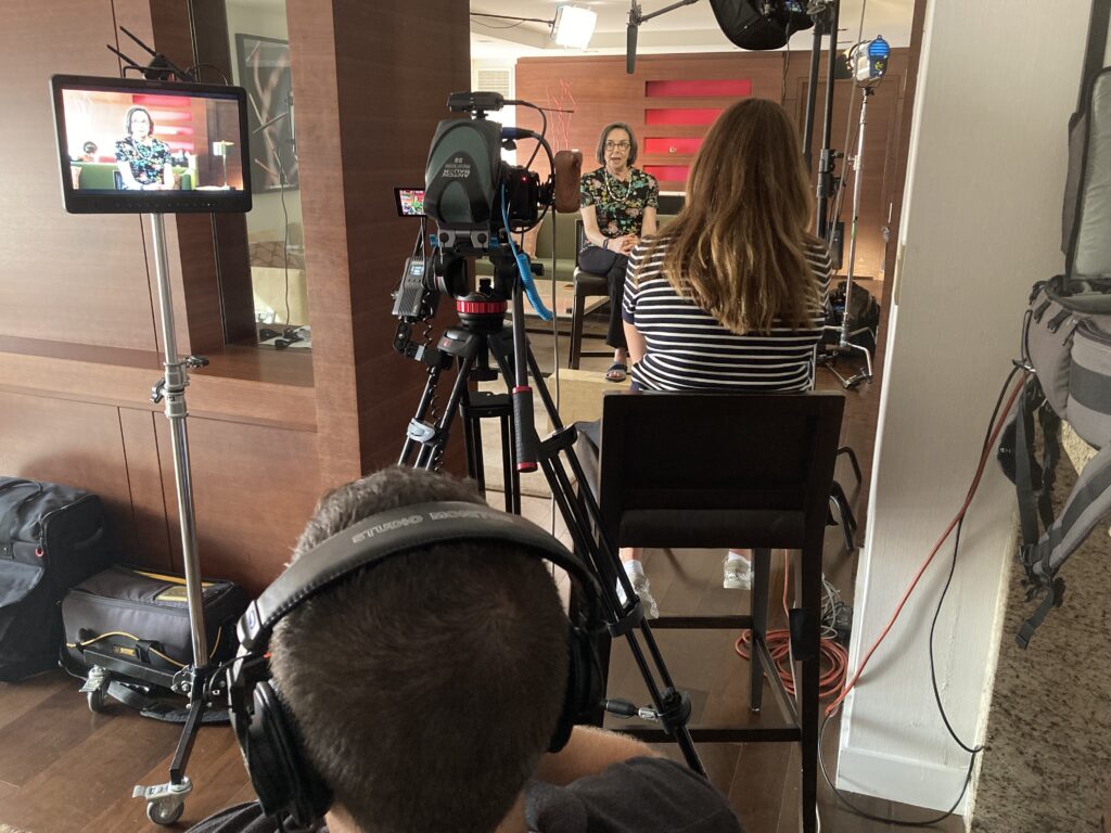 An image of a woman conducting an interview that is being recorded as part of a PSA video production.